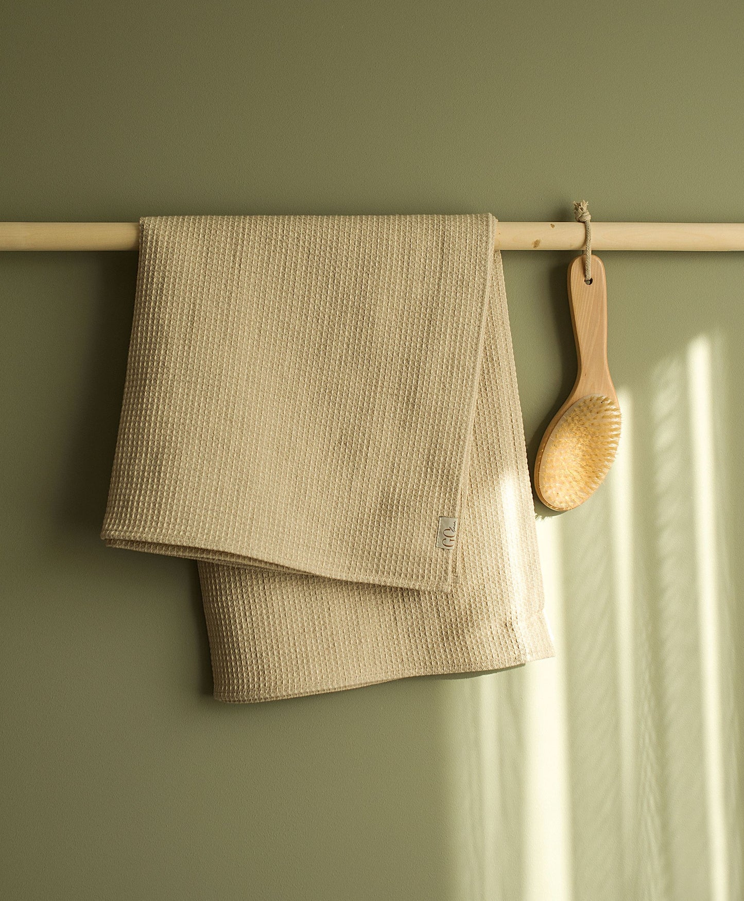 Large bath towel, linen, waffle, hung on the wooden towel hook