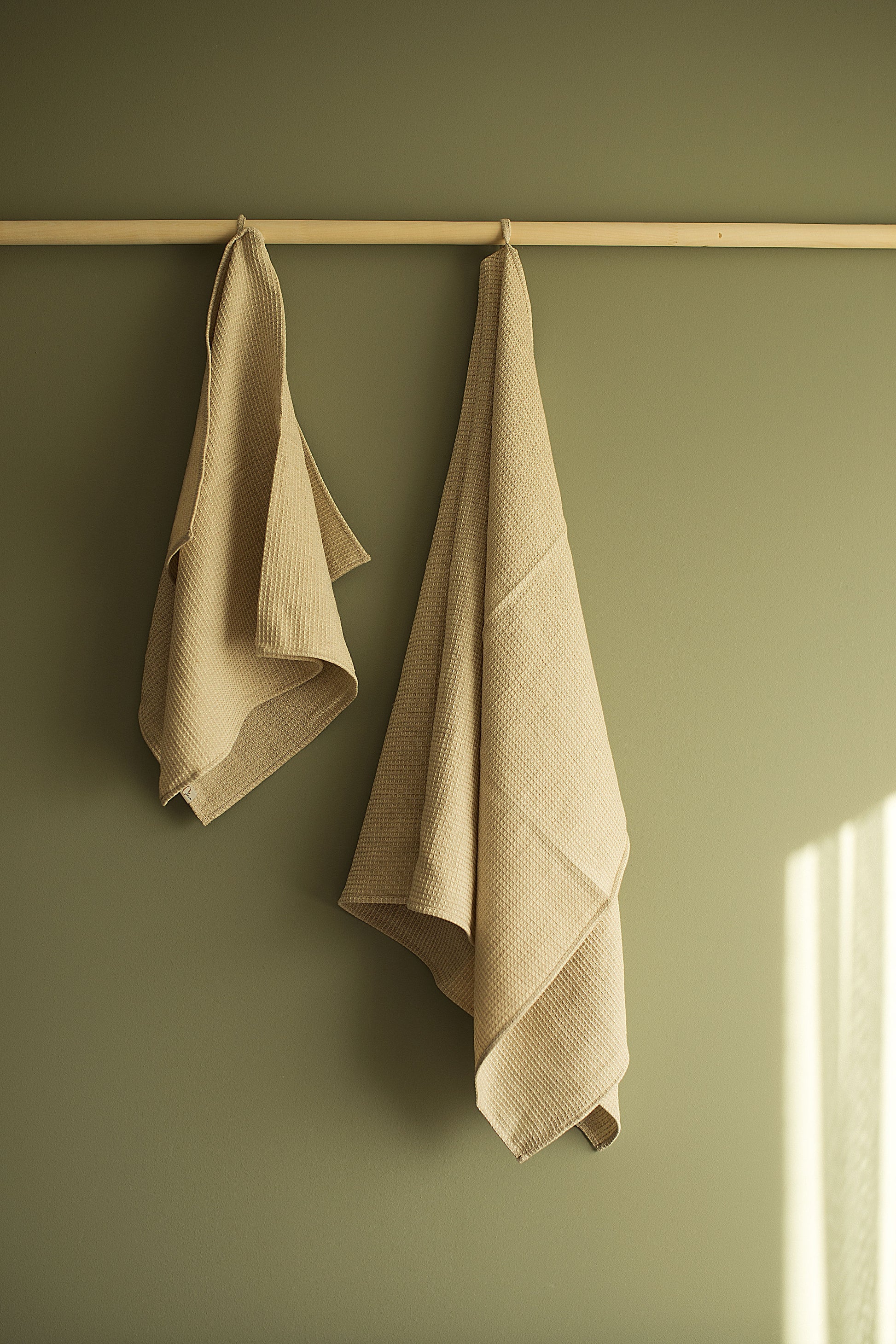 towels with hooks, hanging on the wooden towel holder